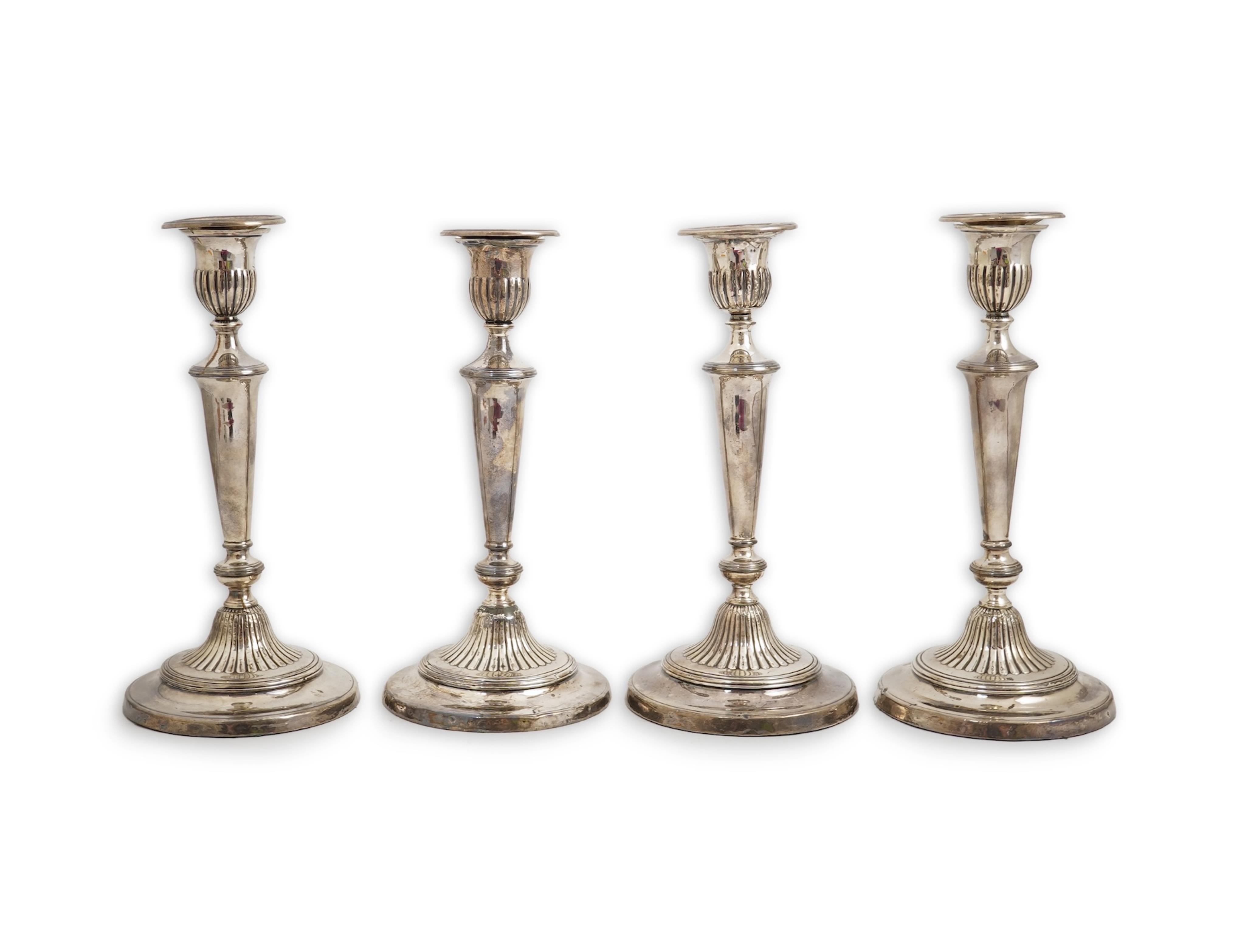 A set of four George III silver candlesticks by John Green, Roberts, Mosley & Co